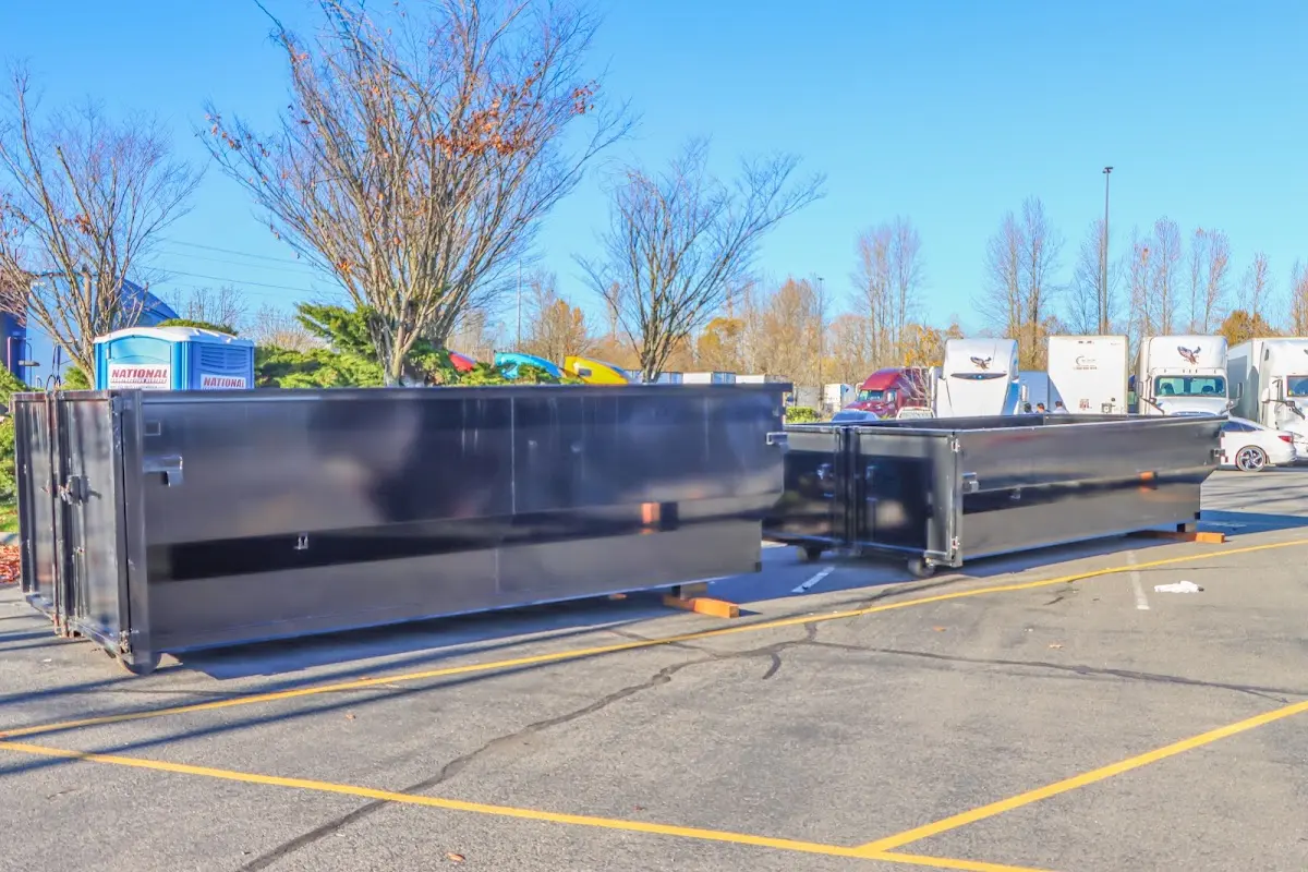 Professional dumpster rental service with roll-off container on residential driveway in Miami Springs